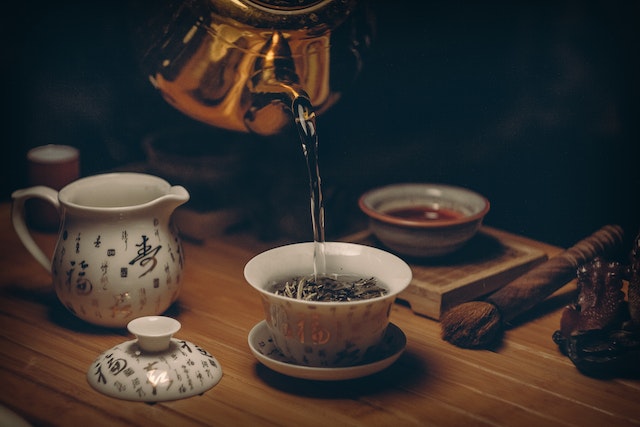 Fitoterapia - Fotografia de um chá sendo derramado na xícara